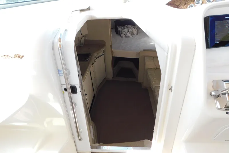 Slide: The Image of Interior view of 1997 Sea Ray 330 Express Cruiser, featuring kitchenette and seating area. - 43