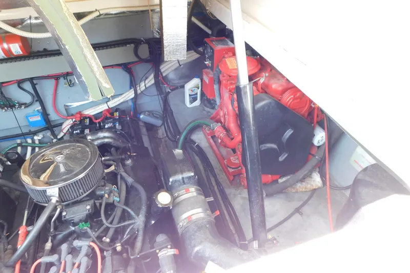 Slide: The Image of Engine compartment of a 1997 Sea Ray 330 Express Cruiser, showcasing mechanical components and wiring. - 88