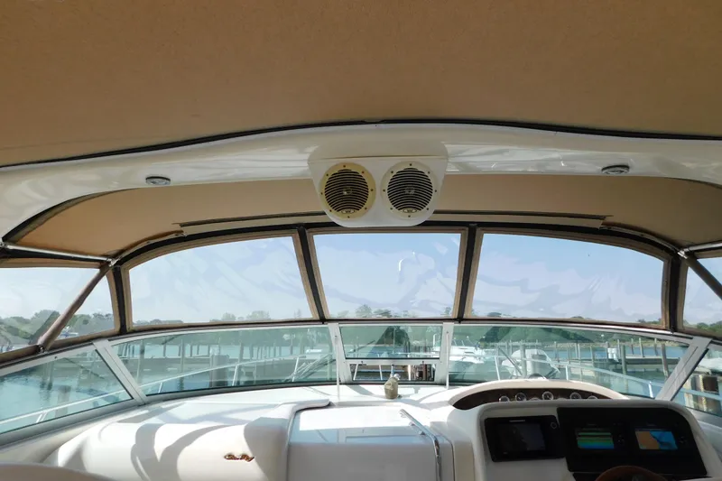 Slide: The Image of Interior view of 1997 Sea Ray 330 Express Cruiser helm with clear windows and dashboard. - 41