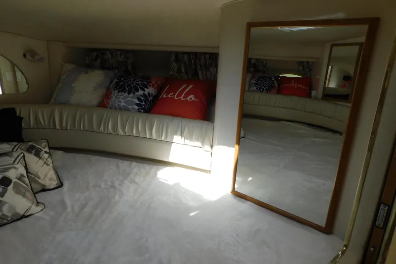 Slide: The Image of Interior of 1997 Sea Ray 330 Express Cruiser with cozy seating and decorative pillows. - 59