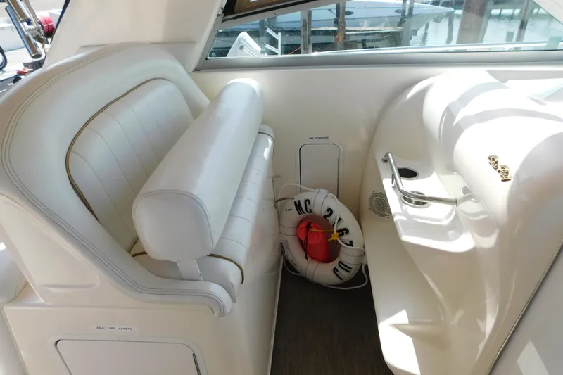 Slide: The Image of Interior of 1997 Sea Ray 330 Express Cruiser with white seating and life preserver. - 39