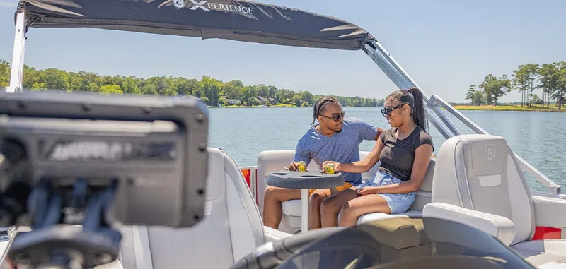 Slide: The Image of A couple sits on a boat enjoying drinks on a lake. - 15