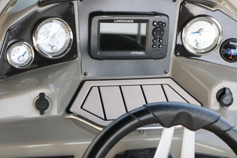 Slide: The Image of Dashboard of 2022 Stingray 192 SC boat with gauges and navigation system. - 35
