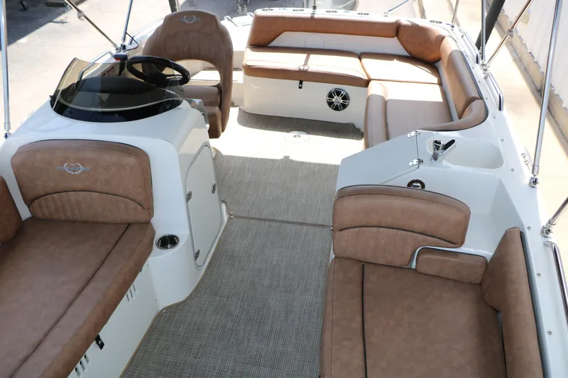 Slide: The Image of 2022 Stingray 192 SC boat interior with tan seating and modern helm design. - 29