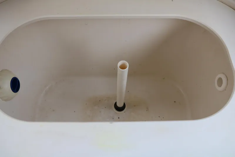 Slide: The Image of 2022 Stingray 192 SC boat compartment with drainage pipe and plug. - 36