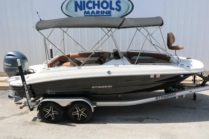 Slide: The Image of 2022 Stingray 192 SC boat with canopy on trailer at Nichols Marine dealership. - 12