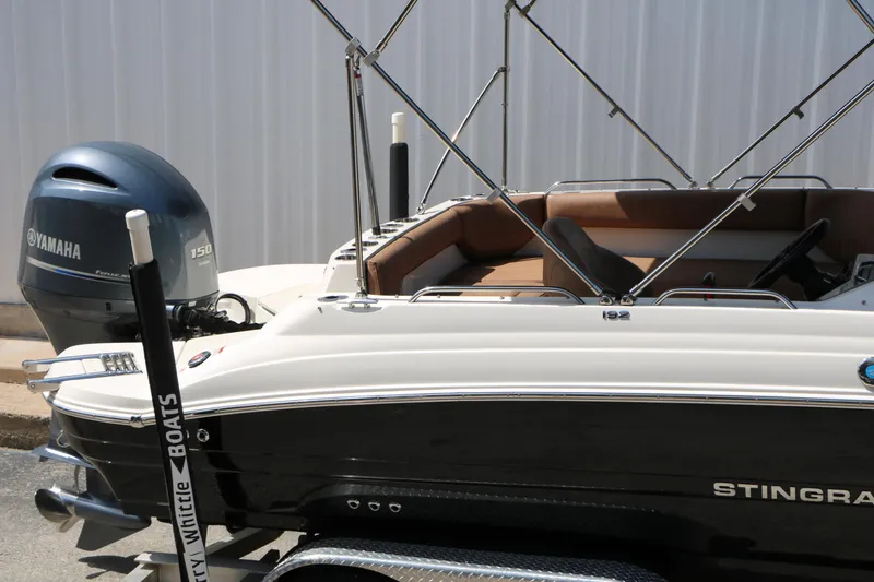 Slide: The Image of 2022 Stingray 192 SC boat with Yamaha 150 engine, parked on a trailer. - 15