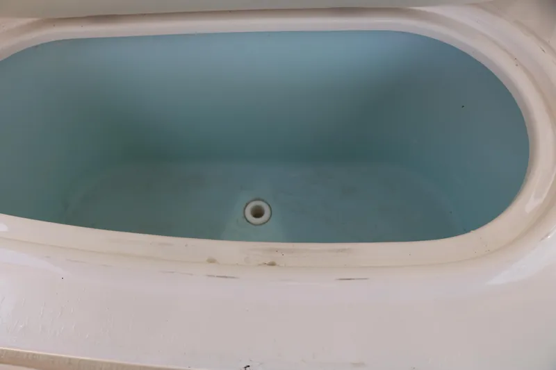 Slide: The Image of 2022 Stingray 192 SC boat storage compartment, empty and clean. - 43