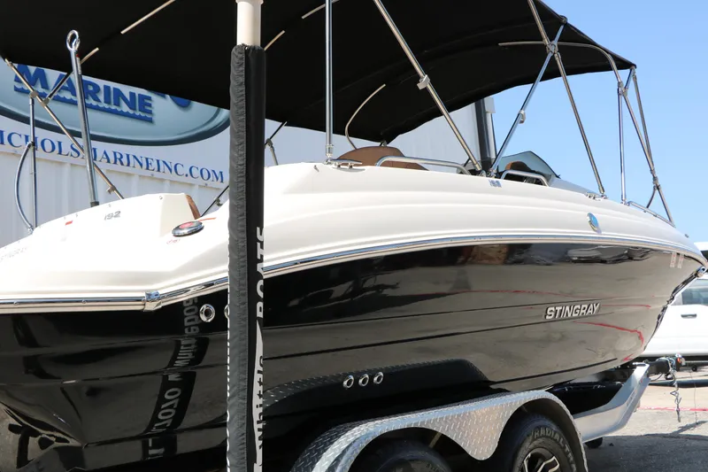 Slide: The Image of 2022 Stingray 192 SC boat on trailer, featuring sleek black and white design. - 6