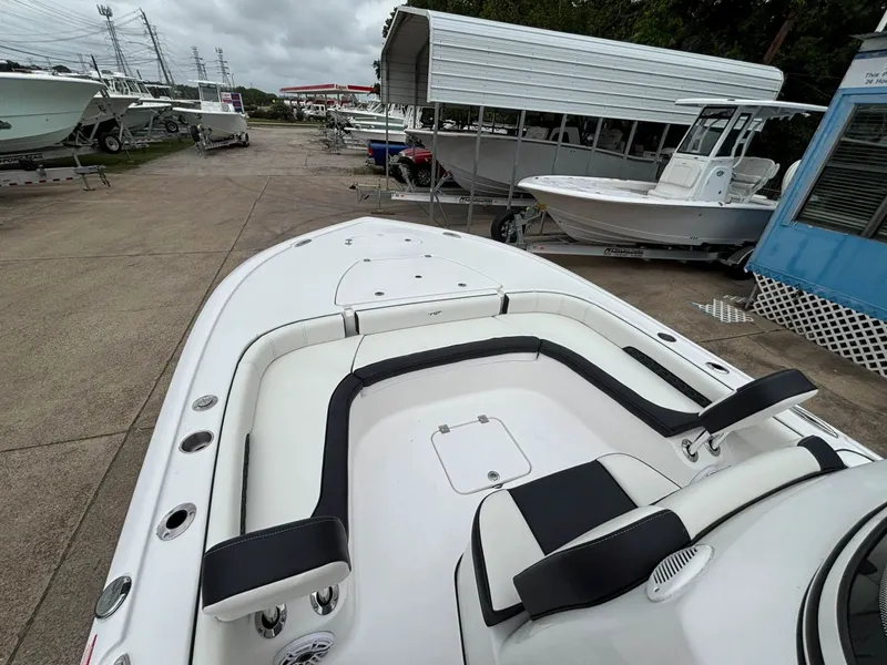 Slide: The Image of The image shows the deck of a Tidewater 2500 Carolina Bay boat with white and black seating. - 4