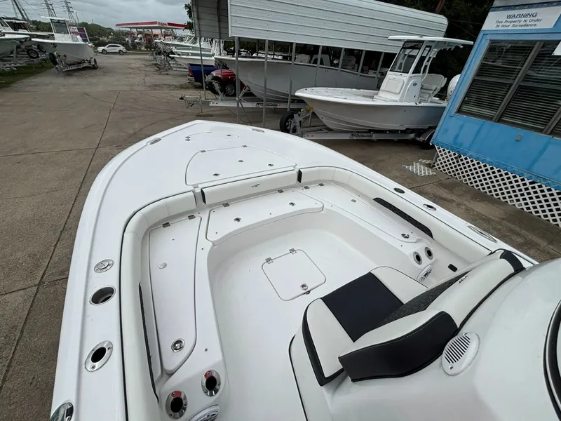 Slide: The Image of The image shows the deck of a Tidewater 2500 Carolina Bay boat with white upholstery. - 6