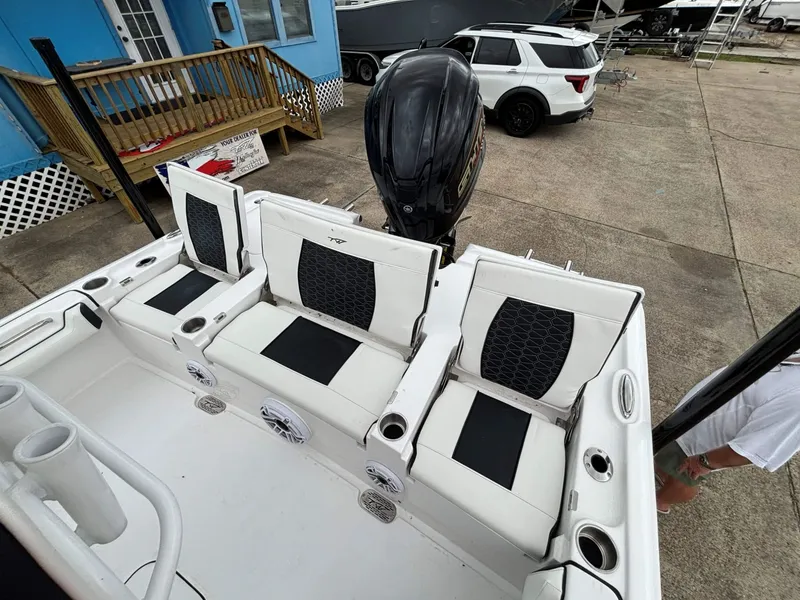 Slide: The Image of The image shows the stern of a Tidewater 2500 Carolina Bay boat with white seating. - 10