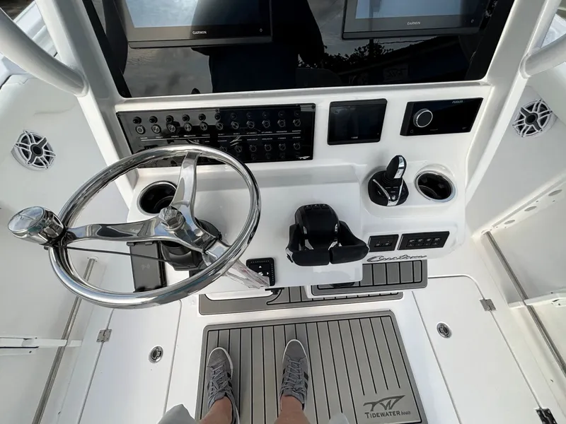 Slide: The Image of The image shows the helm of a Tidewater 272 Center Console Adventure boat with modern instruments. - 3