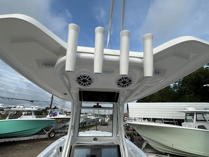 Slide: The Image of View of a Tidewater 272 Center Console Adventure's hardtop with speakers and fishing rod holders. - 8