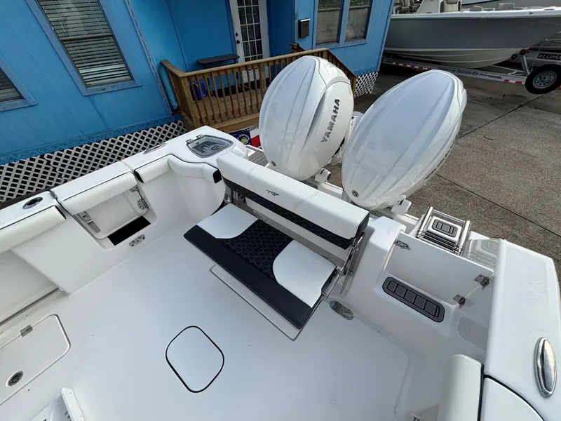 Slide: The Image of The image shows the stern of a Tidewater 272 Center Console Adventure boat with two outboard engines. - 30