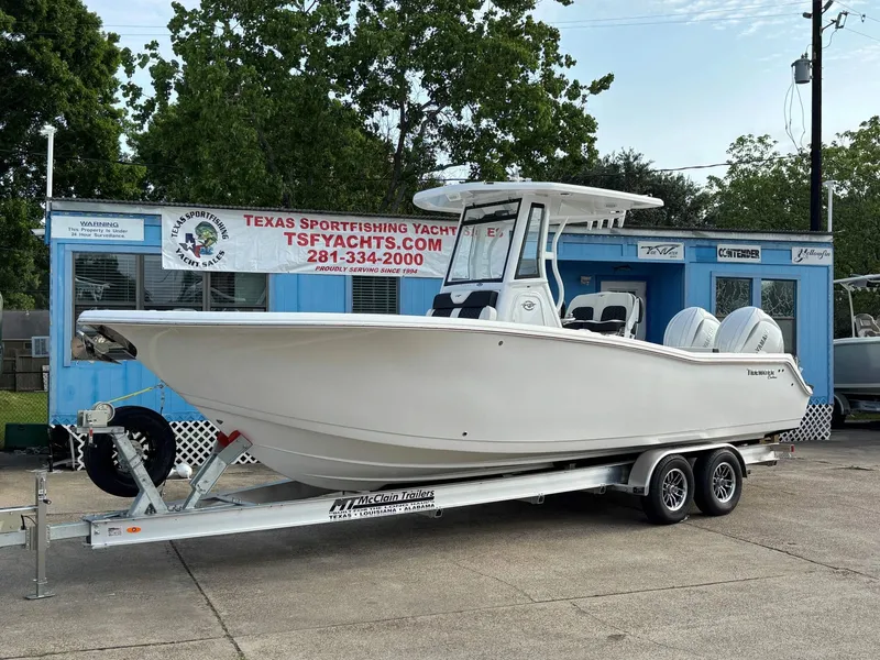 The Image of 2026 Tidewater 272 Center Console Adventure on a trailer in front of a blue building. - 1