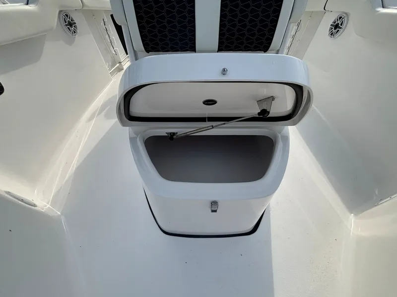 Slide: The Image of An open storage compartment on a boat with a white deck and black details. - 27