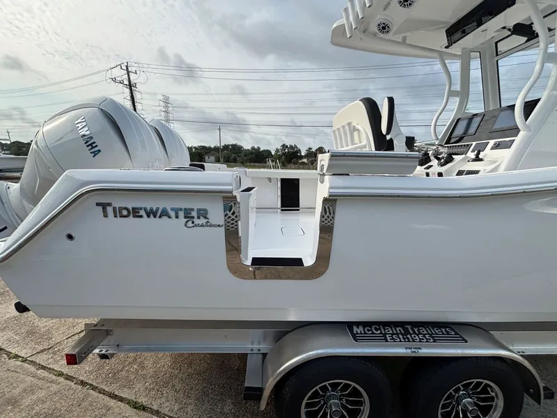 Slide: The Image of A Tidewater 272 Center Console Adventure boat on a trailer, featuring a Yamaha engine. - 21