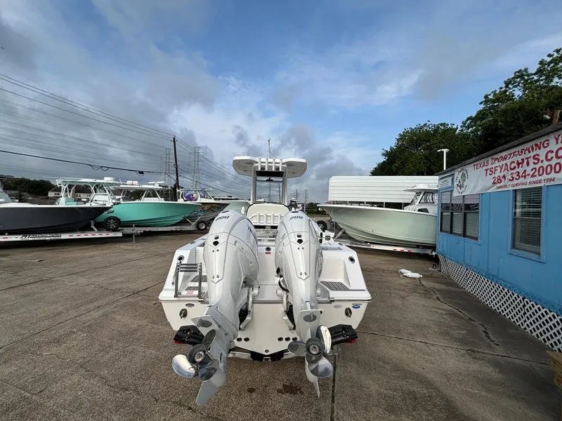 Slide: The Image of Two outboard motors are mounted on the stern of a boat in a parking area. - 20