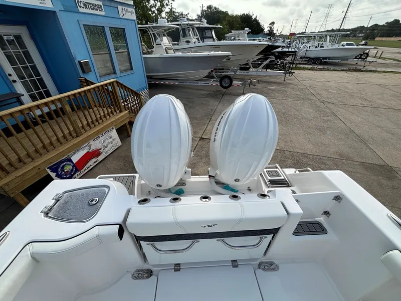 Slide: The Image of Two outboard motors on a boat parked on a lot, with other boats in the background. - 29
