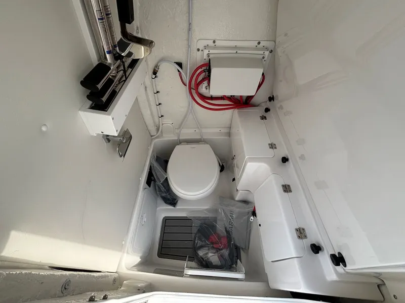 Slide: The Image of Interior view of a boat with a toilet and storage, clean and well-organized. - 28