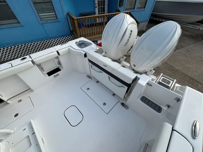 Slide: The Image of The image shows the stern of a Tidewater 272 Center Console Adventure boat with two outboard engines. - 31