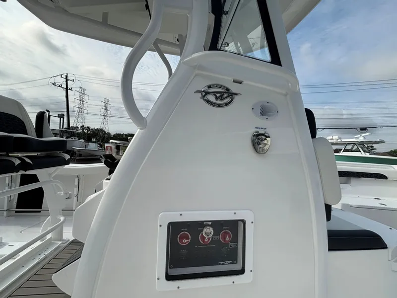 Slide: The Image of The image shows the helm of a 2026 Tidewater 272 Center Console Adventure boat. - 22