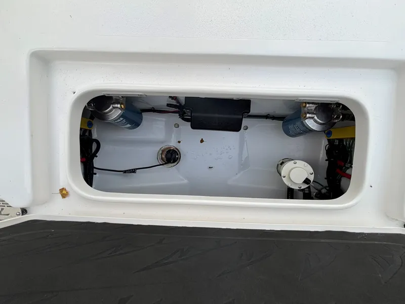 Slide: The Image of An open compartment in the boat reveals technical components and wiring. - 26