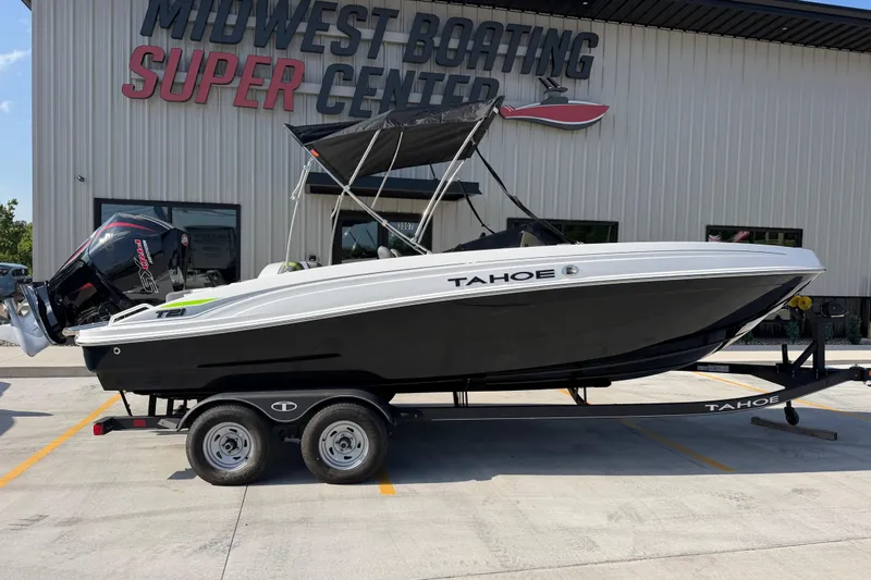 Slide: The Image of A 2024 Tahoe T21 boat on a trailer in front of a boating center. - 1