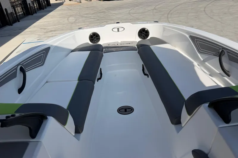 Slide: The Image of 2024 Tahoe T21 boat interior with seating and speakers, docked outdoors. - 23