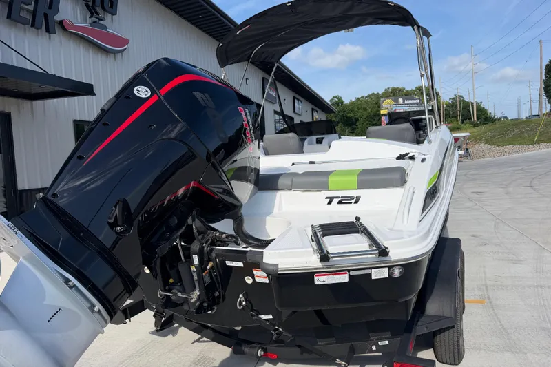 Slide: The Image of 2024 Tahoe T21 boat with powerful outboard motor, parked outdoors on a sunny day. - 4