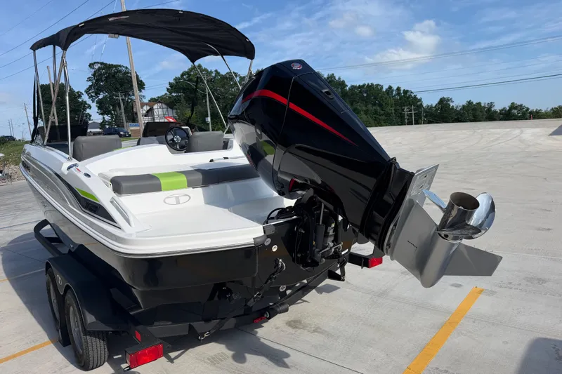 Slide: The Image of 2024 Tahoe T21 boat with outboard motor on trailer, under clear blue sky. - 5