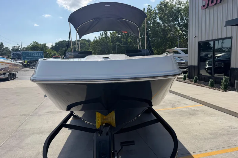 Slide: The Image of 2024 Tahoe T21 boat with canopy, parked outdoors on a sunny day. - 10