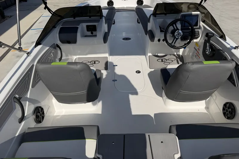 Slide: The Image of 2024 Tahoe T21 boat interior with dual seating, steering console, and modern dashboard. - 11