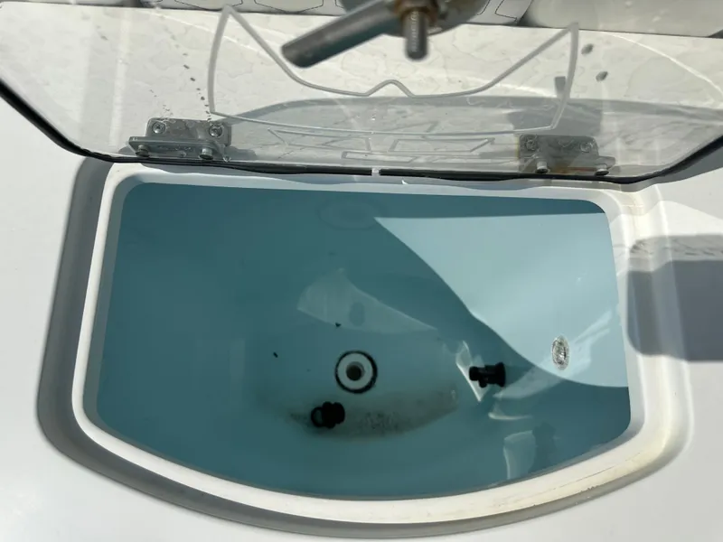 Slide: The Image of An open compartment with water, possibly a livewell on a boat. - 43