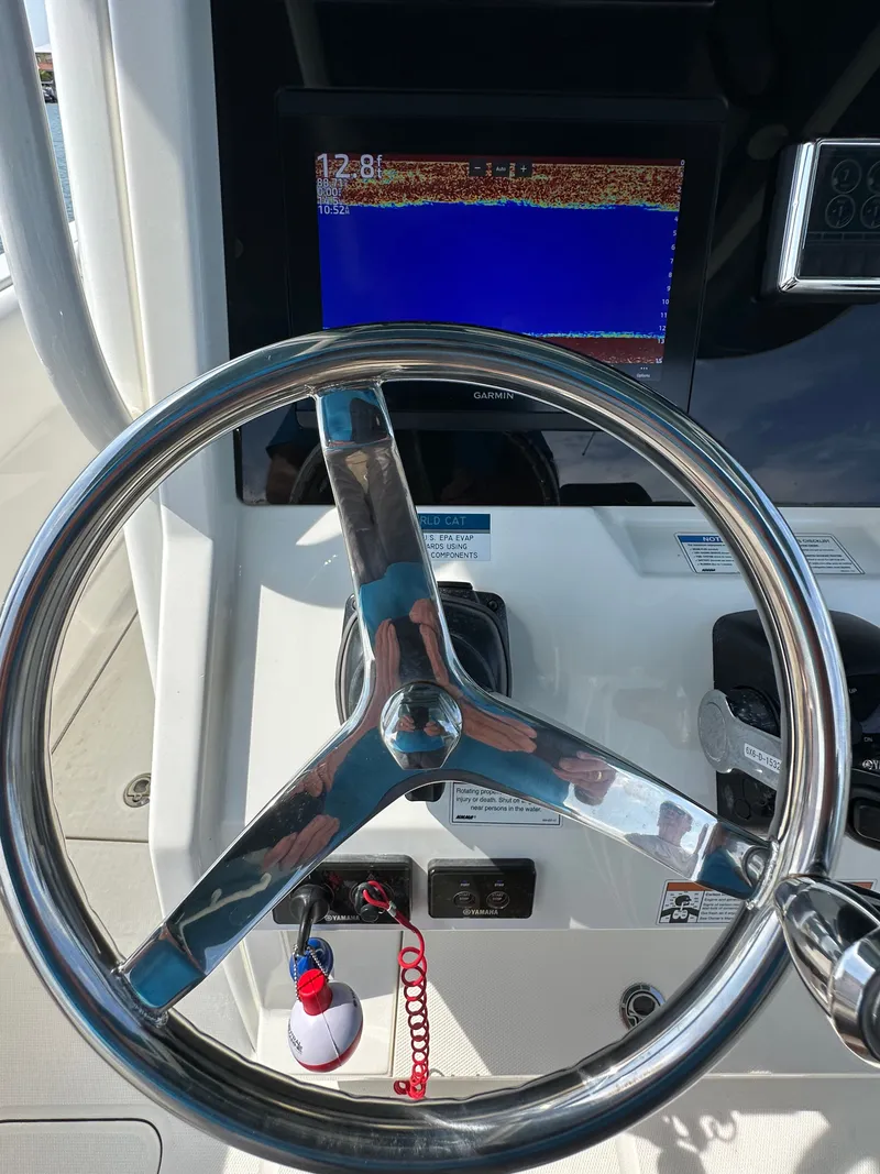 Slide: The Image of The image shows the helm of a World Cat 280 CC-X boat with a display screen. - 46