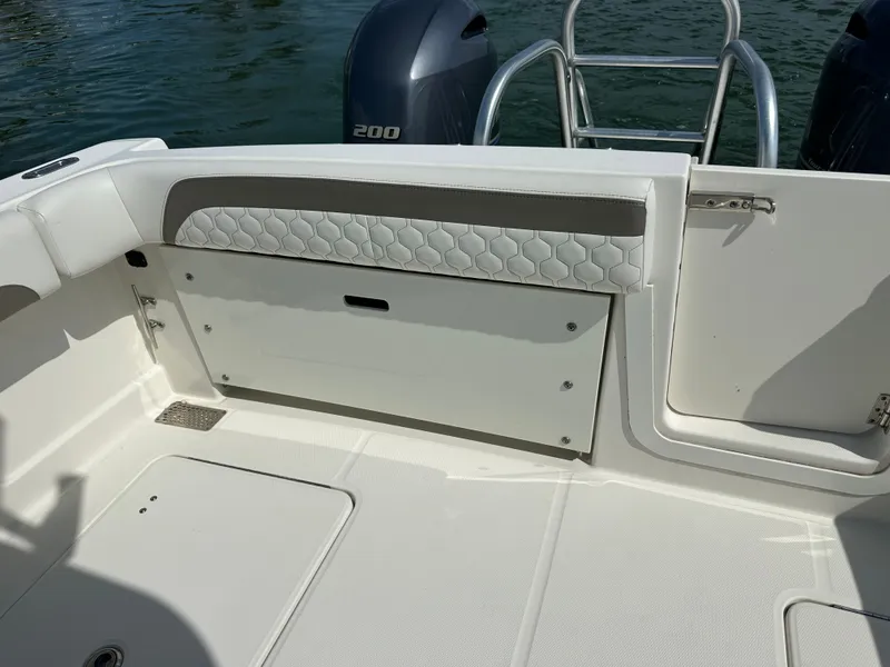 Slide: The Image of The image shows the stern of a boat with two outboard motors and a cushioned bench seat. - 39