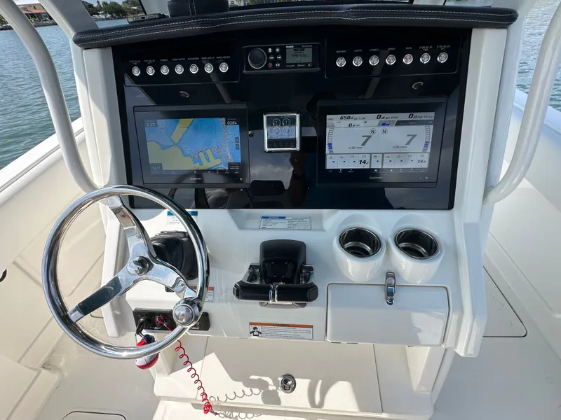 Slide: The Image of The image shows a boat's helm with two large screens and a steering wheel. - 45