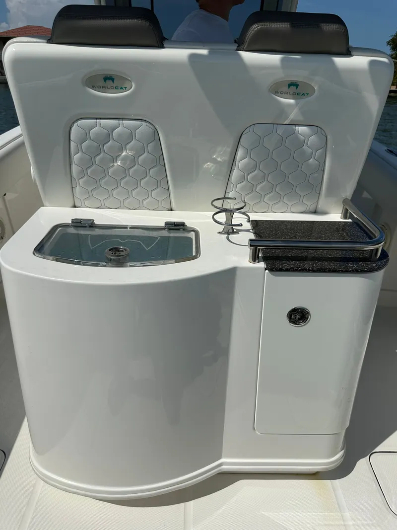 Slide: The Image of The image shows the cockpit of a 2020 World Cat 280 CC-X with sleek seating and a sink. - 42