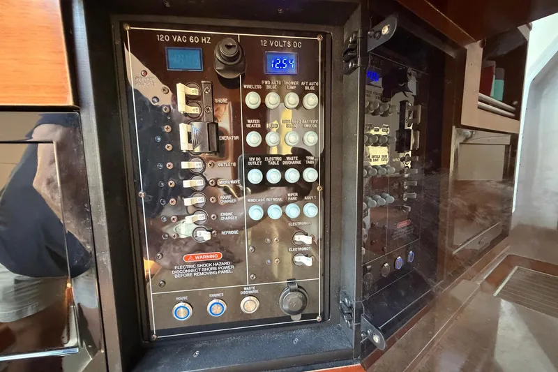 Slide: The Image of Electrical control panel on a 2016 Edgewater 368CC boat, featuring various switches and indicators. - 66