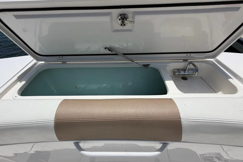 Slide: The Image of Open storage compartment on a 2016 Edgewater 368CC boat, featuring a built-in sink. - 20