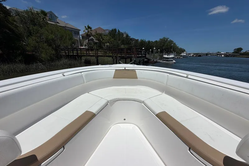 Slide: The Image of 2016 Edgewater 368CC boat interior with spacious seating, docked by a scenic waterfront. - 30