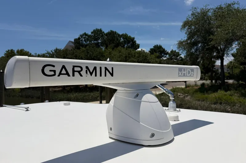 Slide: The Image of Garmin xHD2 radar on 2016 Edgewater 368CC boat, outdoors with trees in background. - 65