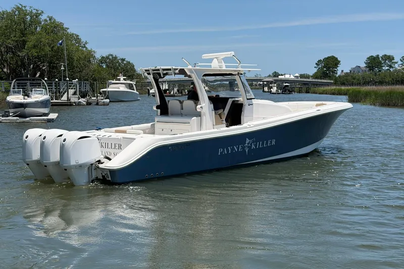 Slide: The Image of 2016 Edgewater 368CC boat with triple engines on calm water, labeled "Payne Killer." - 10