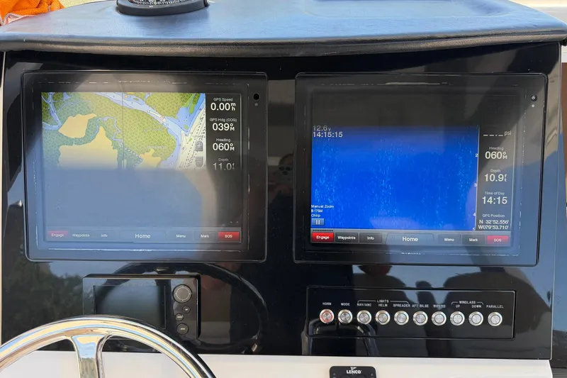 Slide: The Image of Dashboard of a 2016 Edgewater 368CC boat with navigation screens and controls. - 41