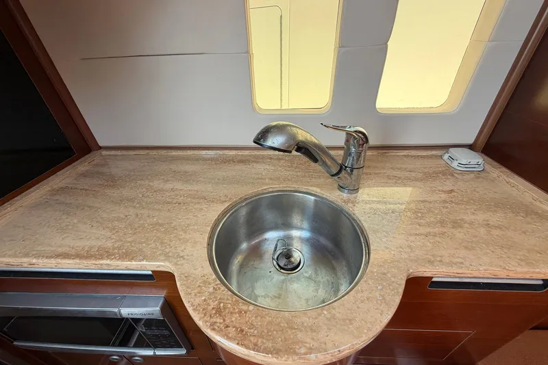 Slide: The Image of 2016 Edgewater 368CC boat interior with sink and countertop in cabin area. - 48