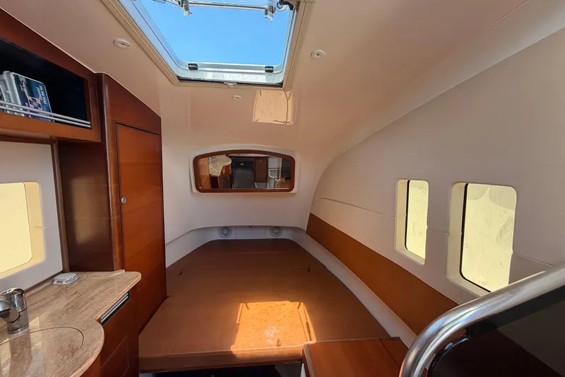 Slide: The Image of Interior of 2016 Edgewater 368CC boat with skylight and wooden finishes. - 44
