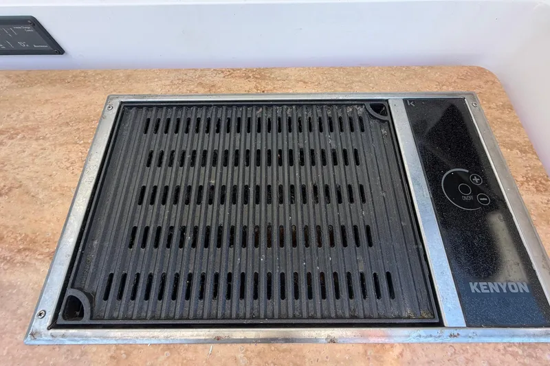Slide: The Image of Built-in Kenyon grill on 2016 Edgewater 368CC boat countertop. - 24