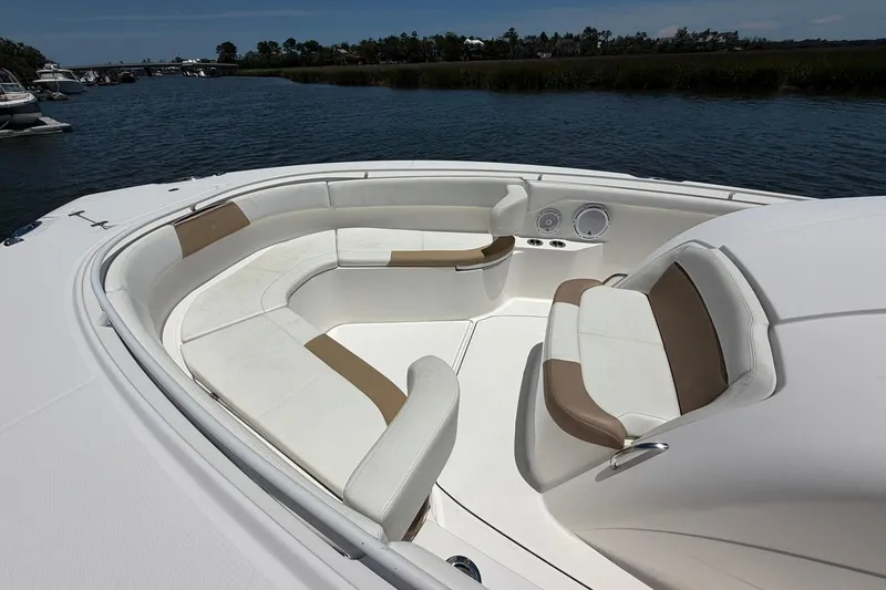 Slide: The Image of 2016 Edgewater 368CC boat interior with spacious seating on calm water. - 16