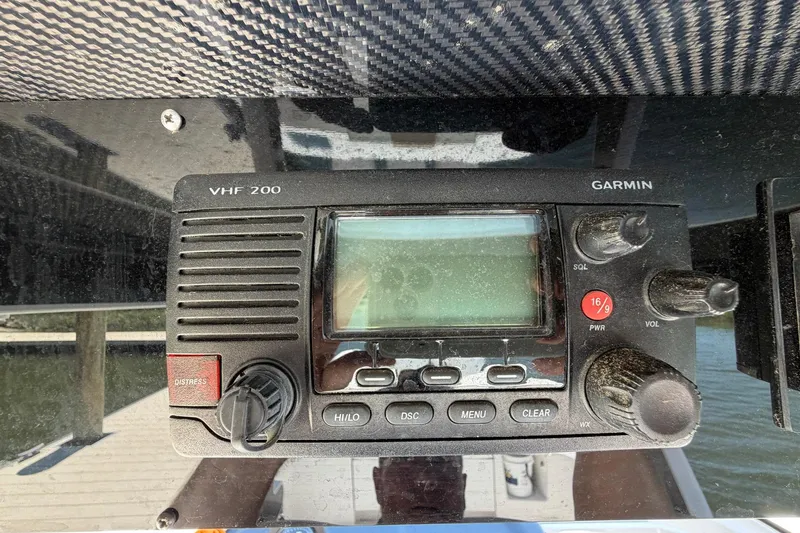 Slide: The Image of VHF 200 marine radio on 2016 Edgewater 368CC boat dashboard. - 57